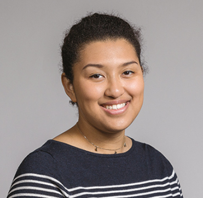 Ava Jamerson sitting for a headshot in a photo studio