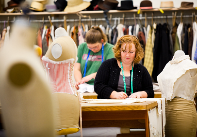 Students working in a theater costume workshop